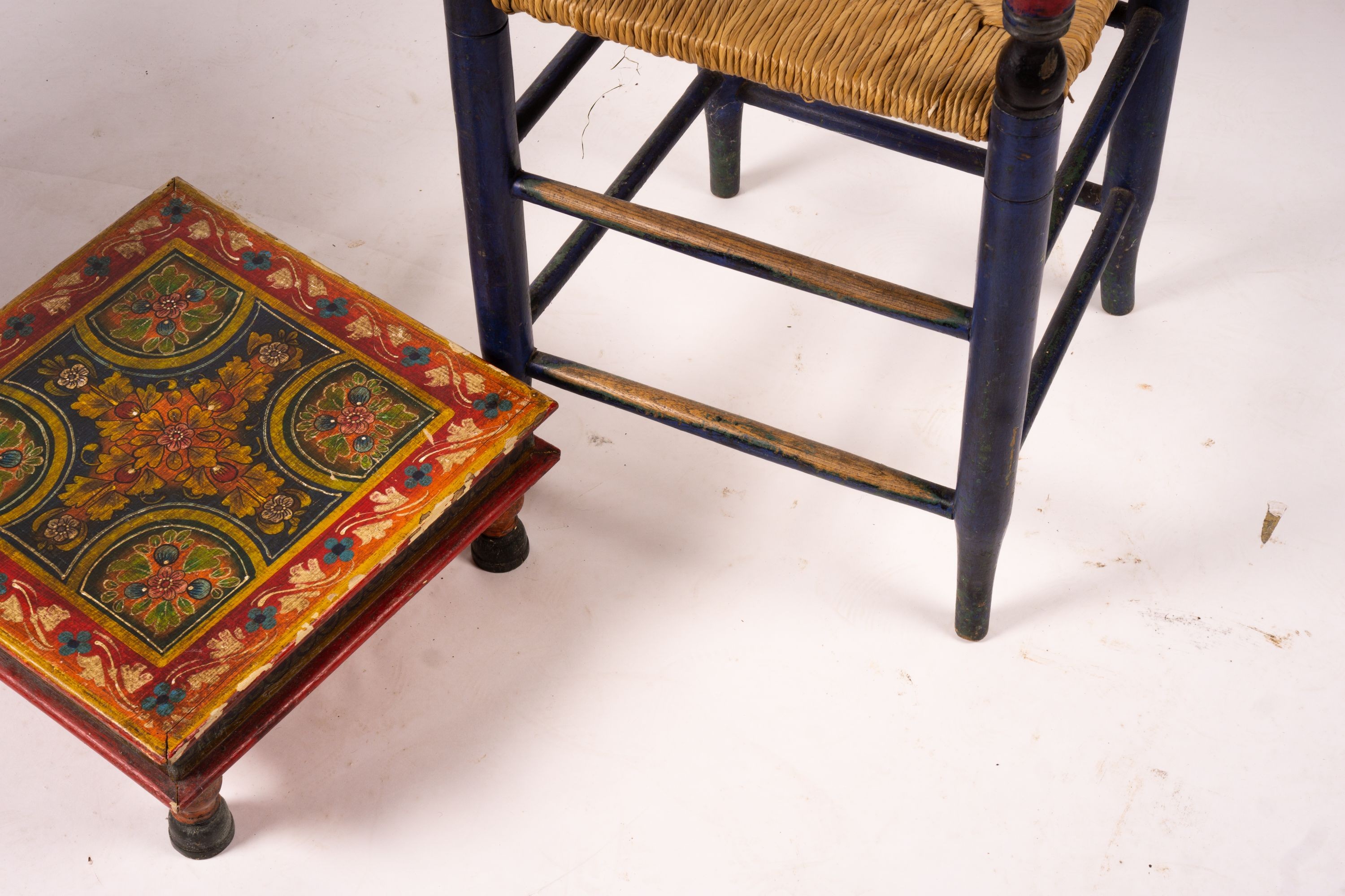 Two 19th / early 20th century Swiss painted rush seat chairs, together with a square low table